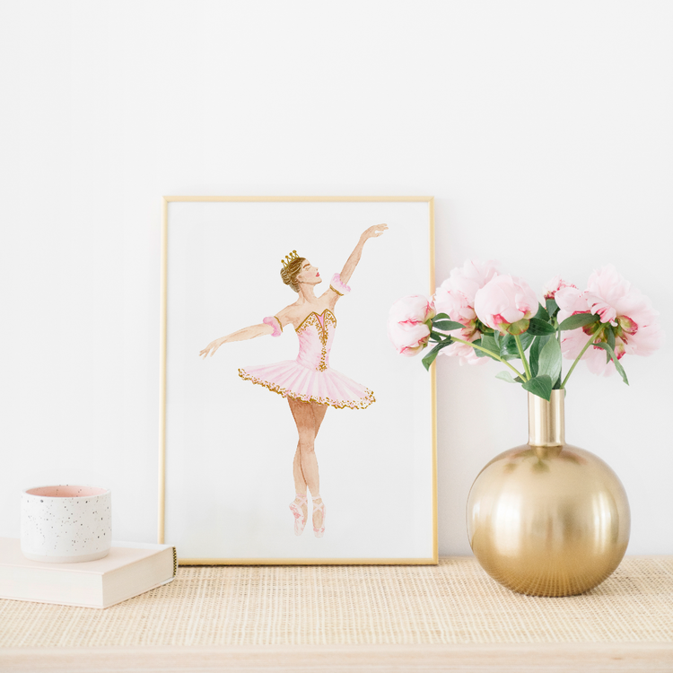 A watercolor art print featuring Sugar Plum Fairy from the Nutcracker in her pink tutu. The background has a gold vase and pink flowers.