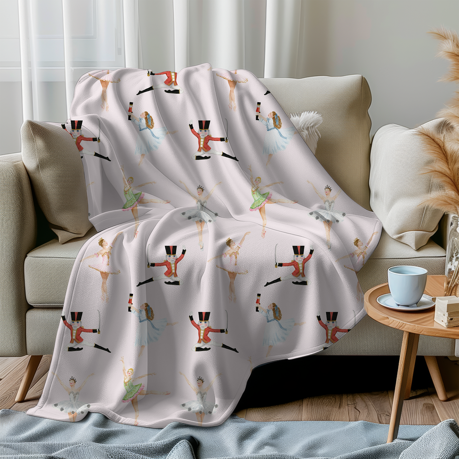A pink Nutcracker themed minky blanket, draped over a sofa in a living room setting.