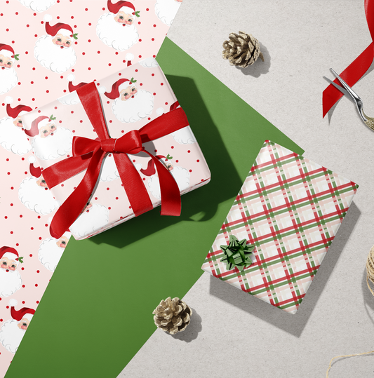 Santa Claus themed gift wrap with a red bow on a green background, featuring a pattern with Santa and pine cones.