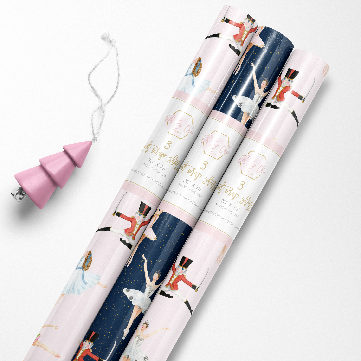 Rolls of pink and navy blue luxury wrapping paper with Nutcracker ballet characters.